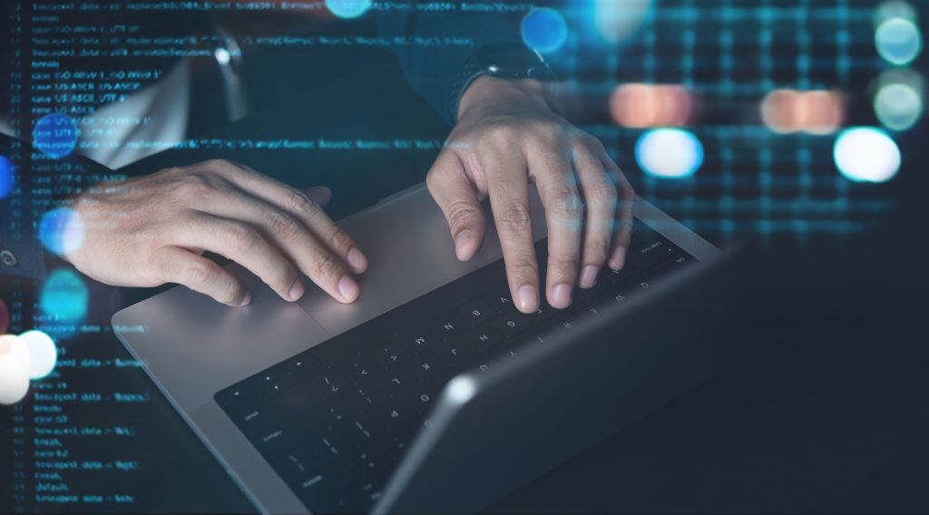 Man coding on a laptop 